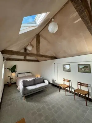 a living room with a couch and a bed at Cambridgeshire Wabi-sabi in Barrington