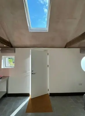 a white room with a ceiling with a skylight at Cambridgeshire Wabi-sabi in Barrington