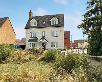 a large white house with a black roof at Colchester Spacious Double Rooms in CO4 in Mile End