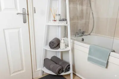 a bathroom with a towel rack next to a shower at The Falcon's Nest - Central in Bury Saint Edmunds