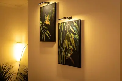 three framed paintings hang on a wall in a room at The Falcon's Nest - Central in Bury Saint Edmunds