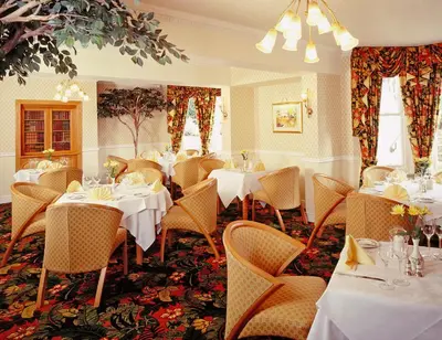 a dining room with white tables and chairs at Arundel House Hotel in Cambridge