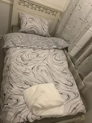 a bed with a blanket and pillows on it at At Apex House single room in Horndon on the Hill