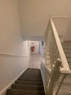 a staircase in a house with a stair case at At Apex House single room in Horndon on the Hill
