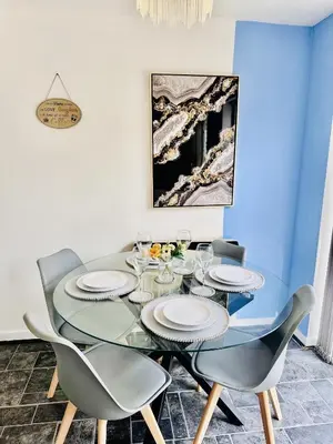 a dining room with a glass table and chairs at Kinlett close in Mile End