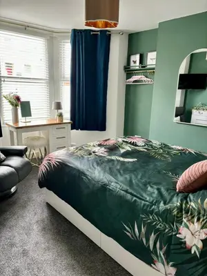 a bedroom with a bed and a desk at Stylish and Chic Seaside Apartment in Southend-on-Sea
