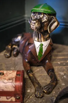 a statue of a dog wearing a green hat and tie at Luxury 2 Bed Manor House Hot Tub Cinema Room SkyTV in Saffron Walden