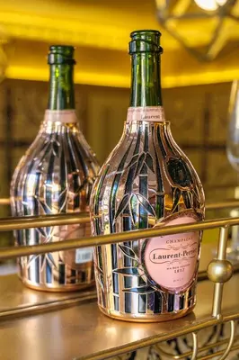 two bottles of wine sitting on a shelf at Luxury 2 Bed Manor House Hot Tub Cinema Room SkyTV in Saffron Walden