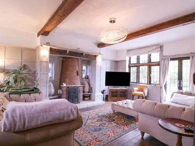 a living room with a couch and a fireplace at Home by the Sea in Clacton-on-Sea