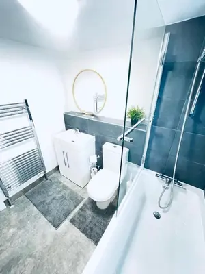 a bathroom with a toilet and a tub and a sink at 2 Bed Flat - Sleeps 5 - Parking - Wifi in Cambridge
