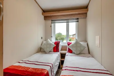 two beds in a small room with a window at 2 Bed in Welney oc-s29764 in Welney