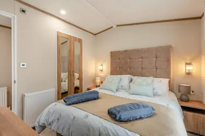 a bedroom with a large bed with two pillows on it at 2 Bed in Welney oc-s29764 in Welney