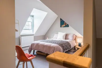 a bedroom with a bed in a attic at The Poppies, a stylish Aldeburgh holiday home in Aldeburgh