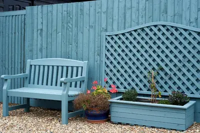 a blue bench sitting next to two potted plants at The Stables Kersey Mill in Whatfield