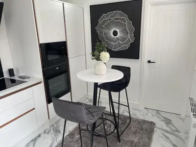 a kitchen with a small table and two chairs at Modern-luxury 1bedroom-EnsuiteBathroom-Garden-Wifi in Basildon