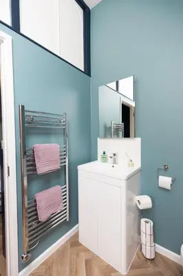 a bathroom with a white sink and a mirror at Central Medieval Grid Unique home with Gated parking in Bury Saint Edmunds