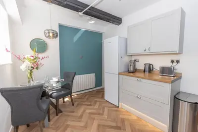 a kitchen and dining room with a table and chairs at Central Medieval Grid Unique home with Gated parking in Bury Saint Edmunds