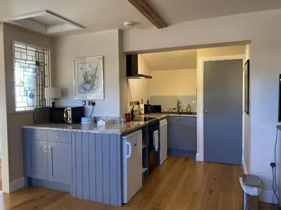 a kitchen with blue cabinets and a counter top at Red lion little barn in Ipswich