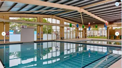 a large swimming pool in a building at 3 Bed Caravan Sleeps 8 - Parking Bbq Pool in Clacton-on-Sea