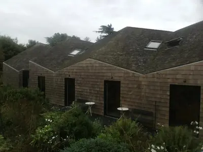 a house with two windows and a roof at Five Acre Barn in Leiston