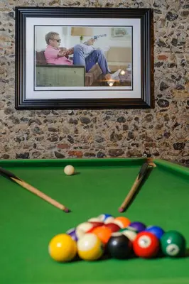 a picture of a pool table with balls and cues at The Famous Harry Potter House in Saffron Walden