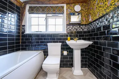 a bathroom with a toilet and a sink and a tub at The Famous Harry Potter House in Saffron Walden