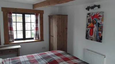 a bedroom with a bed and a window at St Edmunds Brewery in Downham Market