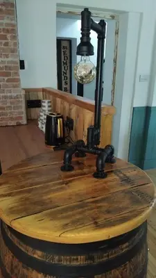 a lamp on top of a wooden table on a barrel at St Edmunds Brewery in Downham Market