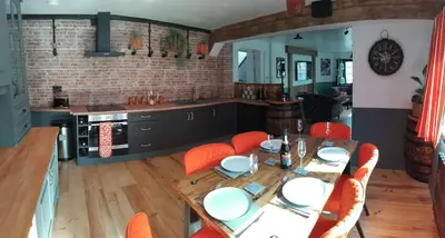 a kitchen and dining room with a table and chairs at St Edmunds Brewery in Downham Market