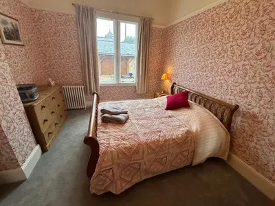 a bedroom with a bed and a window at Cockayne Hatley Hall in Cockayne Hatley