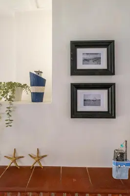 two starfish on a wall with two pictures at 6 Uplands in Thorpeness