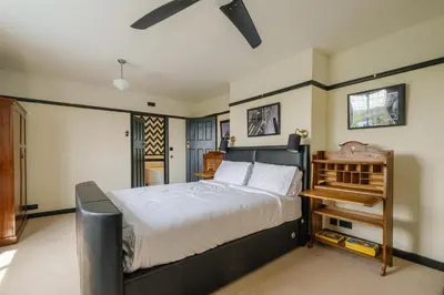 a bedroom with a bed and a ceiling fan at Mill House in Thorpeness
