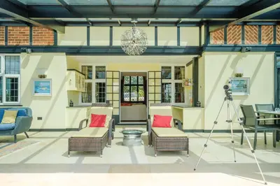a room with chairs and a camera on a tripod at Mill House in Thorpeness