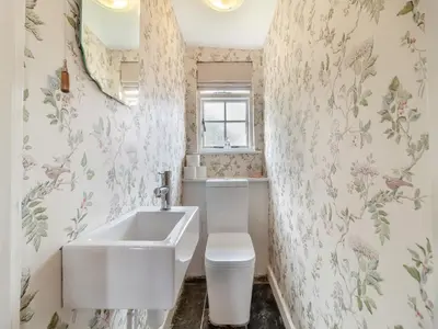 a bathroom with a sink and a toilet at All Saints Cottage in Saffron Walden