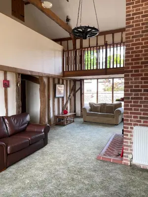 a living room with two couches and a table at Kings Barn - English Countryside Retreat in Lindsell