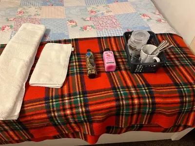 a bed with a blanket with a tray of food on it at Double room in Canvey island with shared bathroom in Hadleigh