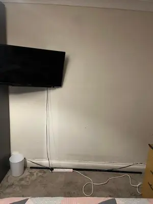 a flat screen tv hanging on a white wall at Double room in Canvey island with shared bathroom in Hadleigh