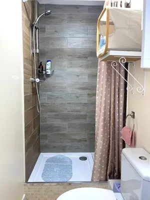 a small bathroom with a shower and a toilet at Penn Gardens Standard Room - 4 in Friern Barnet