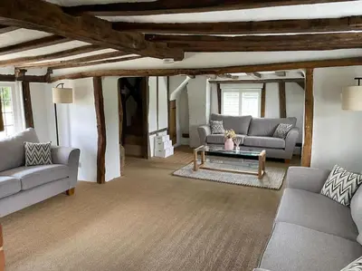 a living room with two couches and a table at Old Cottage - English Countryside Retreat in Lindsell