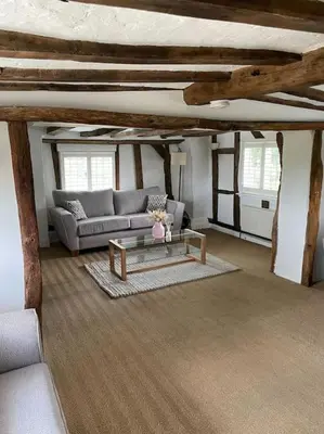 a living room with a couch and a coffee table at Old Cottage - English Countryside Retreat in Lindsell