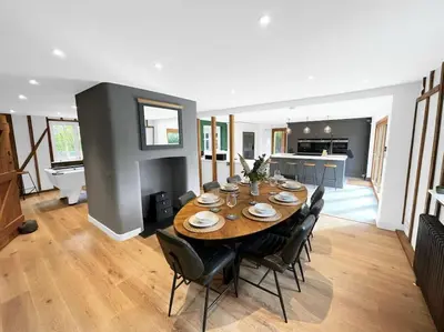 a dining room with a table and chairs at Mallards - English Countryside Retreat in Lindsell