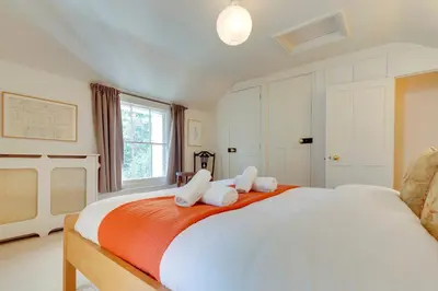 a bedroom with a large white bed with white pillows at Pass the Keys Charming Cottage in City Centre with Free parking in Cambridge