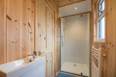 a bathroom with a white sink and a shower at River Retreat, Aldeburgh in Aldeburgh