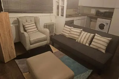 a living room with a couch and a chair at 1 Bed House Sleeps 2 -Free Parking -Tv in Romford