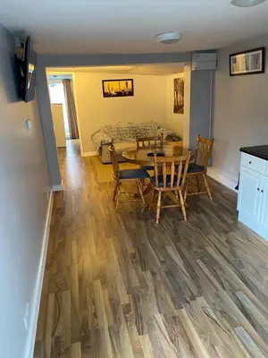 a dining room and living room with a table and chairs at The Shak in Banham