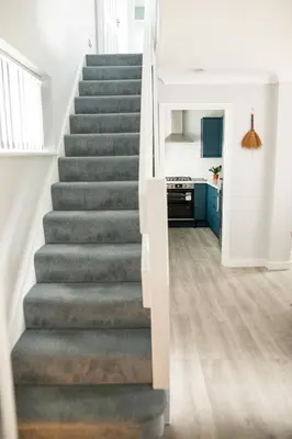 a staircase in a home with a gray carpet at Lovely 3 Bedroom House in Chelmsford in Chelmsford