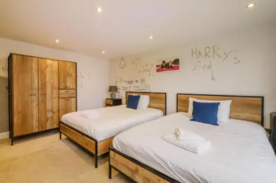 two beds in a room with two bedsskirts at Sandown in Snape