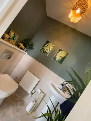 a bathroom with a white toilet and a sink at Cosy room in Great Bromley