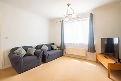 a living room with a couch and a tv at Contractor's Haven 4BED 2BATH House in Ipswich with FREE Parking in Ipswich
