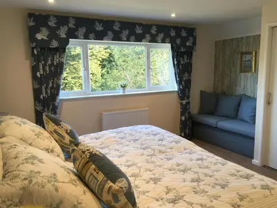 a bedroom with a bed and a window at Tresco - Aldeburgh's hidden gem in Aldeburgh